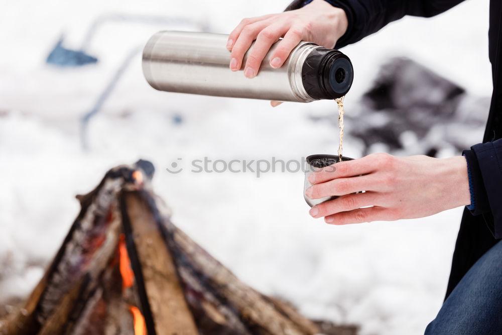 Image, Stock Photo Male hand pouring hot coffee or tea into enamel cup