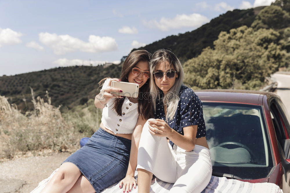 Similar – Image, Stock Photo Stylish women browsing phone on breathtaking landscape
