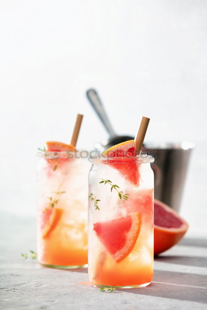 Similar – Two glasses of soft drink with honey- and watermelon, rosemary, ice cubes and drinking straw