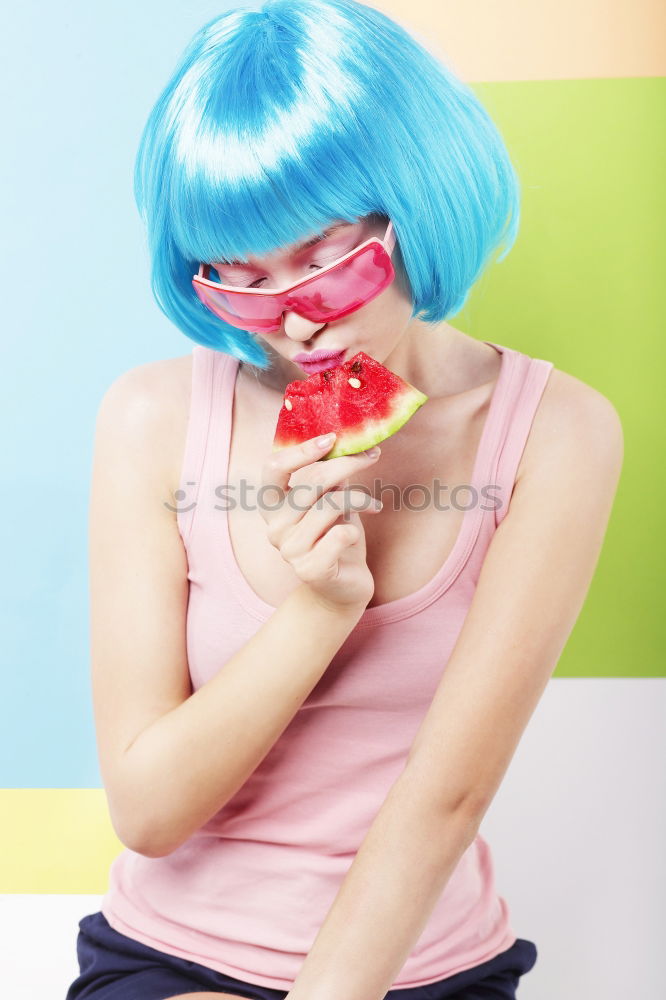 Similar – Young woman with pink hair is licking lollipops