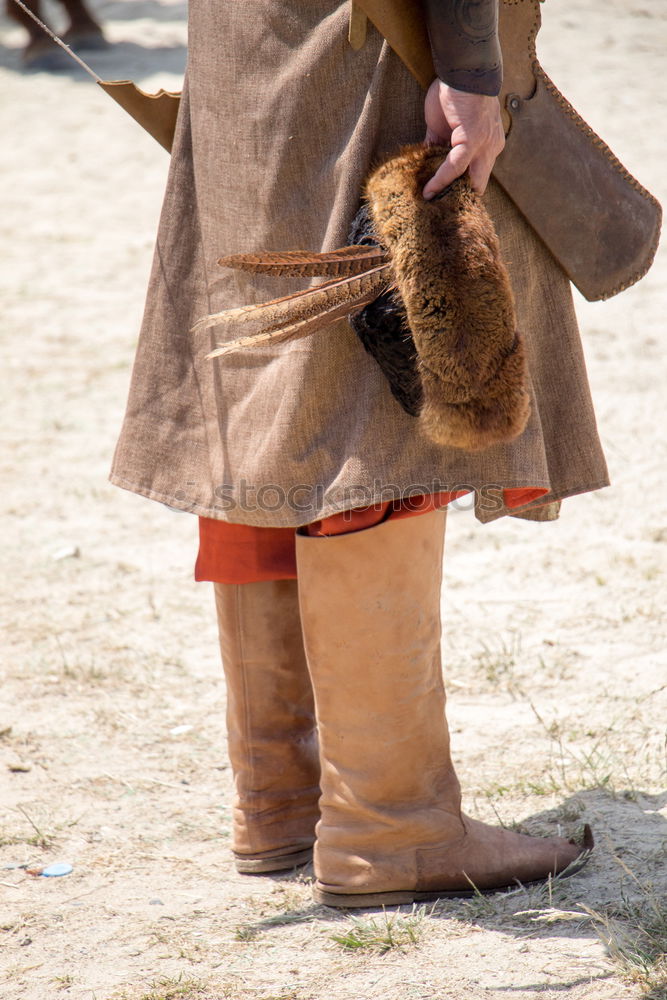 Similar – Image, Stock Photo Portrait of a young male adjusting the saddle on his horse