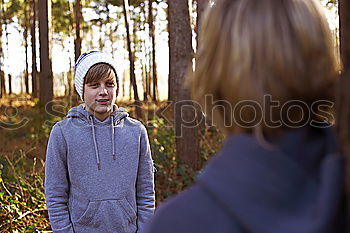 Younger brother looking back at older brother