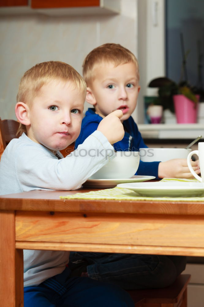 Woman feeding her little girl in kitchen