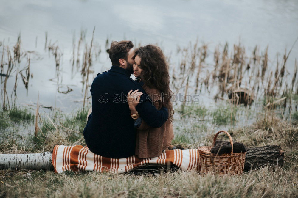 Similar – Couple lying at lake together