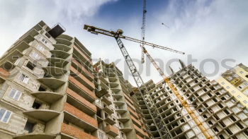 Similar – Construction site with building cranes