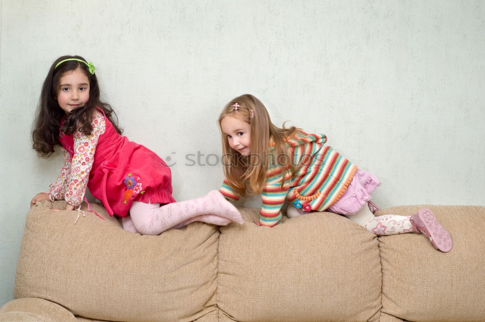 Similar – Image, Stock Photo Kids playing video game sitting on sofa at home