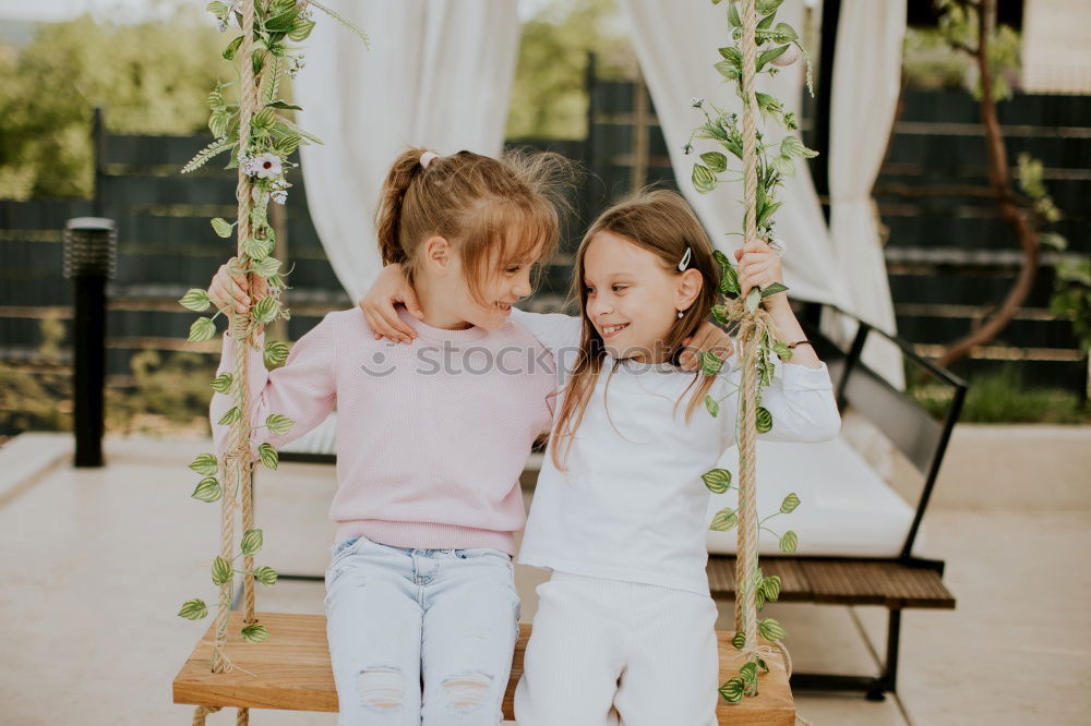 Cute caucasian siblings sitting on slide on playground