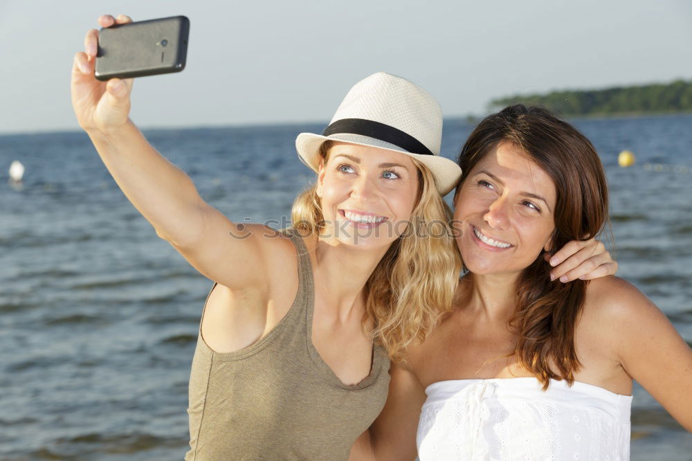 Similar – Image, Stock Photo Two girls taking selfie photograph with smart phone