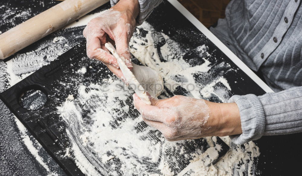 close up view of woman hand cutting nuts with knife