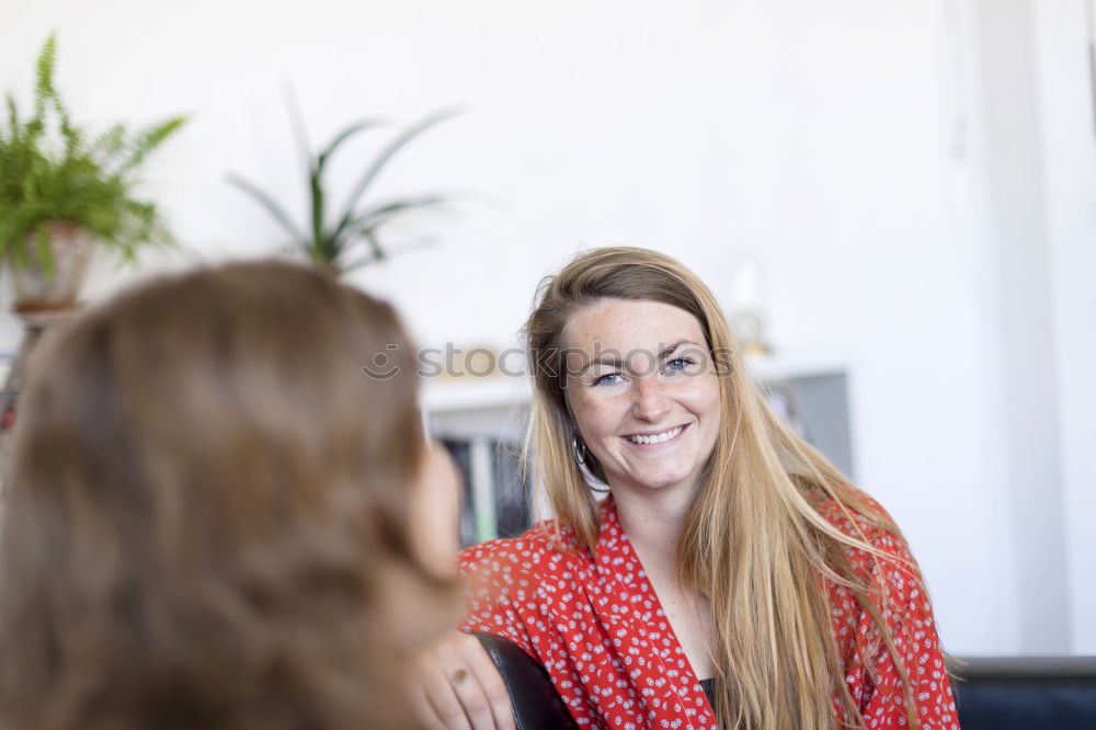 Image, Stock Photo Two friends talking and laughing on a sofa in the living room at home