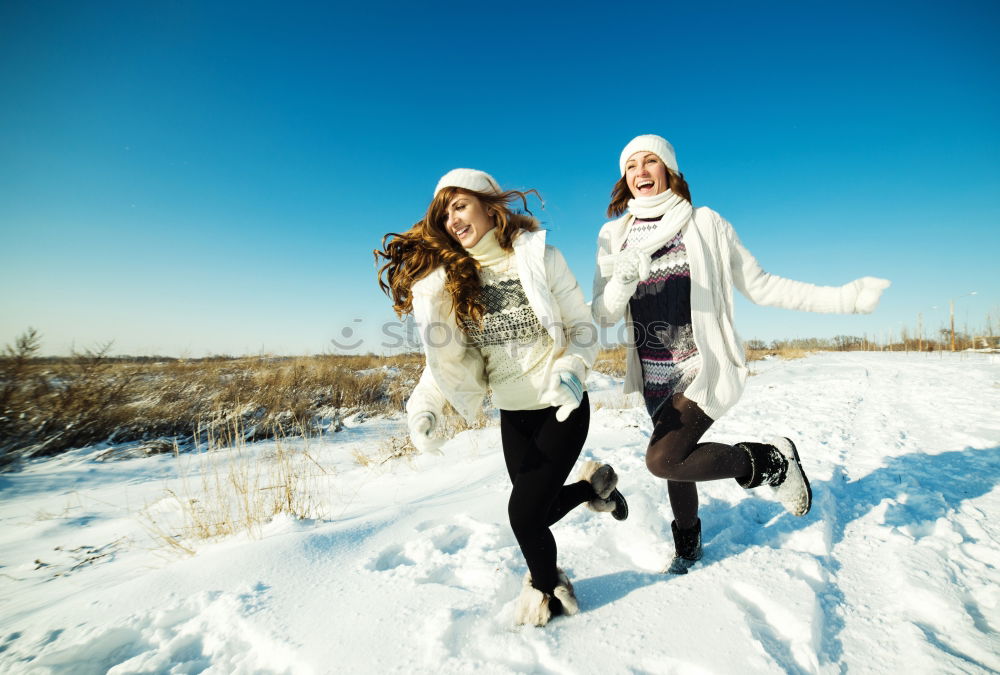 Similar – Teenage girl pulling sled with her little sister through forest