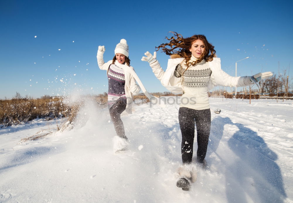 Similar – Young family with children go sledding in winter sunshine