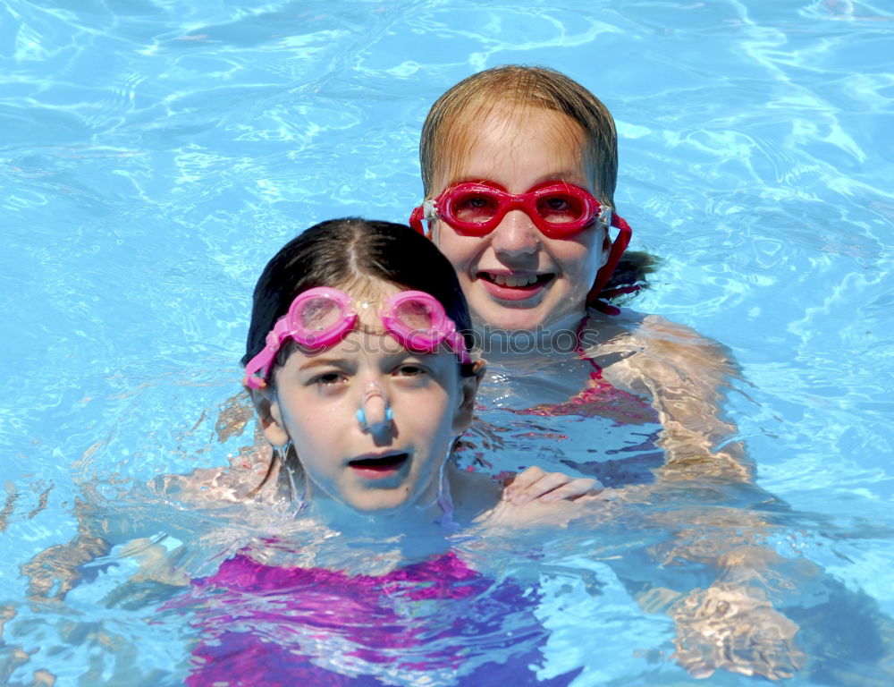 Similar – two little girls playing in the pool at the day time