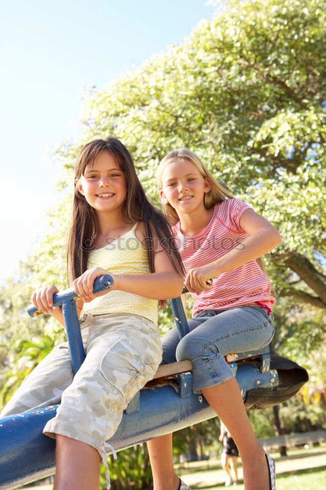 Similar – Two kids riding together wtih a skate board