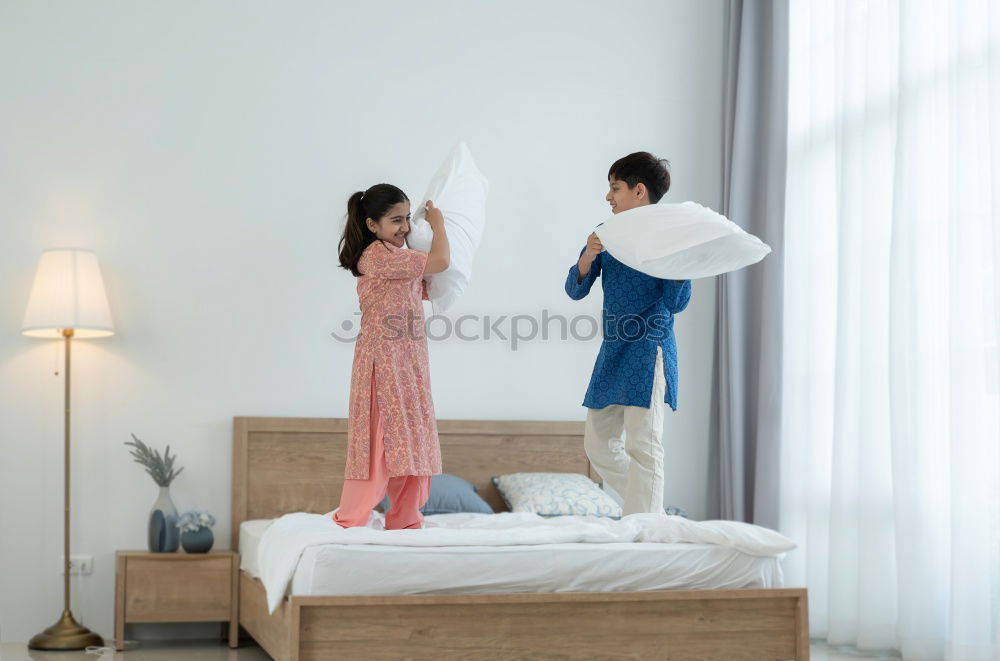 Similar – happy mother and child son playing pillow fight