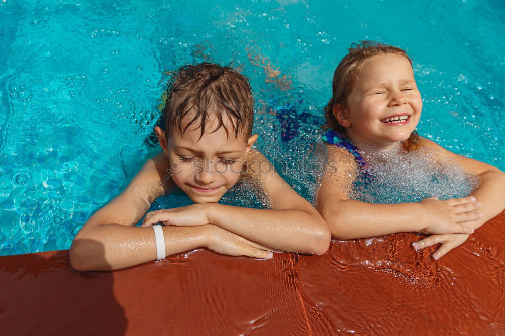 Similar – two little girls playing in the pool at the day time