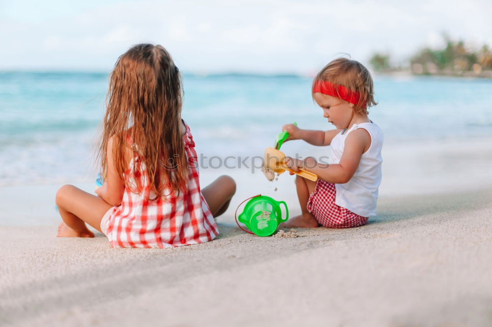 Two happy children playing on the beach