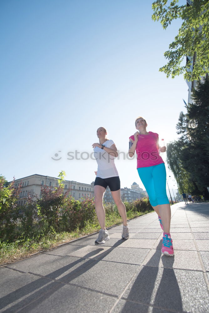 Similar – Image, Stock Photo Young couple running on a seafront promenade