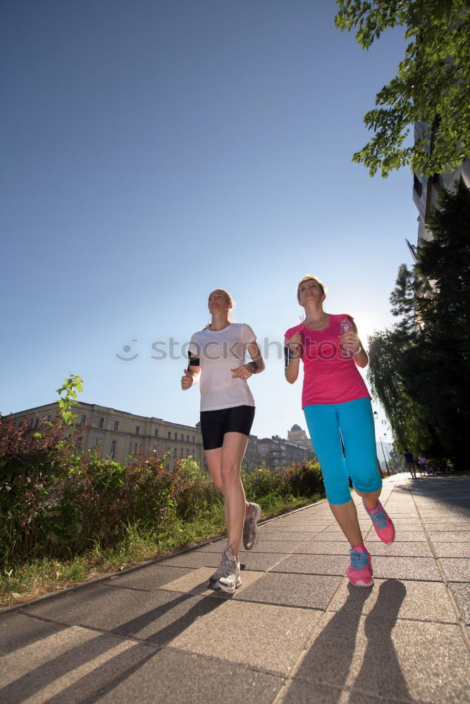 Similar – Image, Stock Photo Young couple running on a seafront promenade