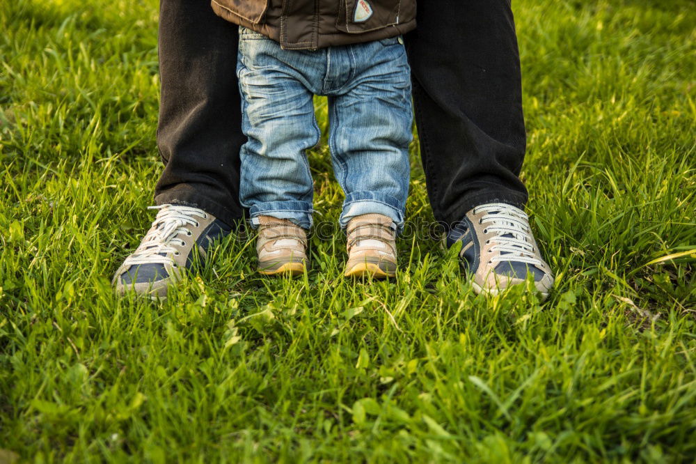 Similar – Image, Stock Photo Grandfather putting shoe to his grandson outdoors