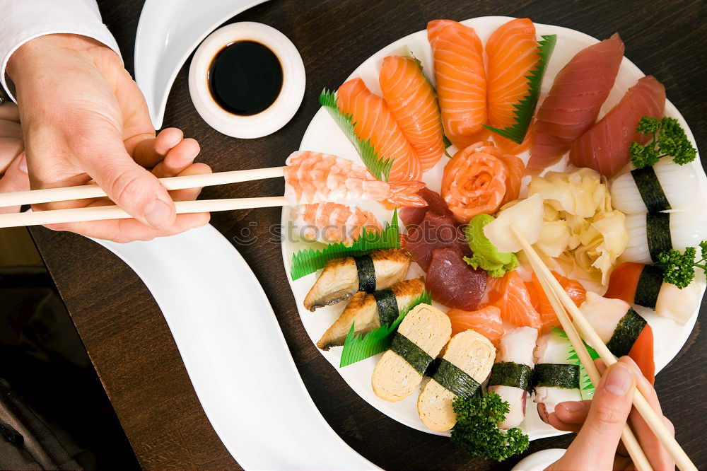 Similar – Crop woman eating sushi