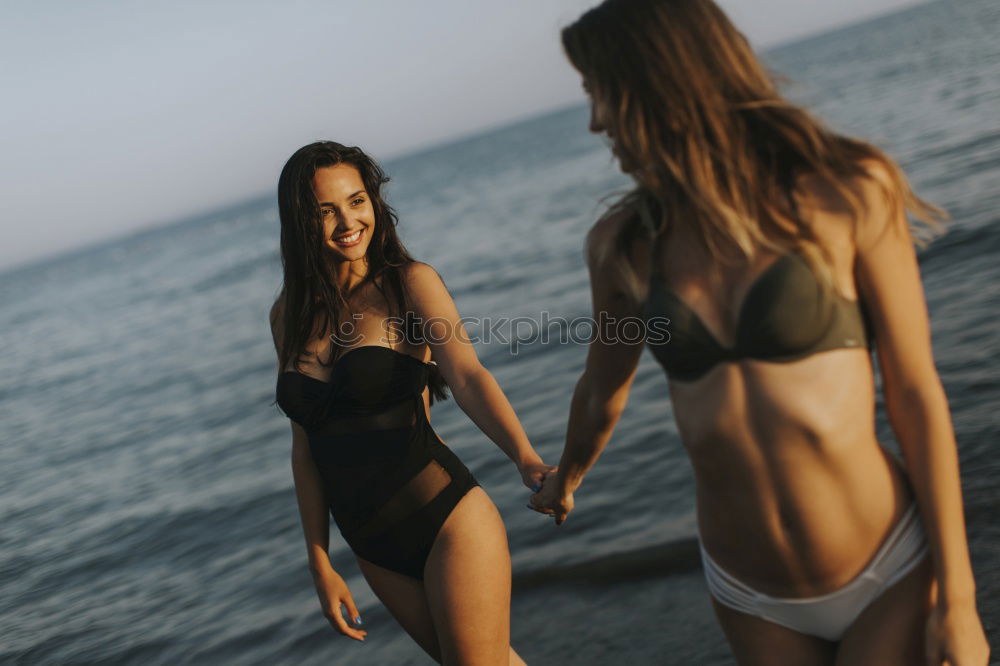 Similar – Group of female friends walking on the beach in sunset