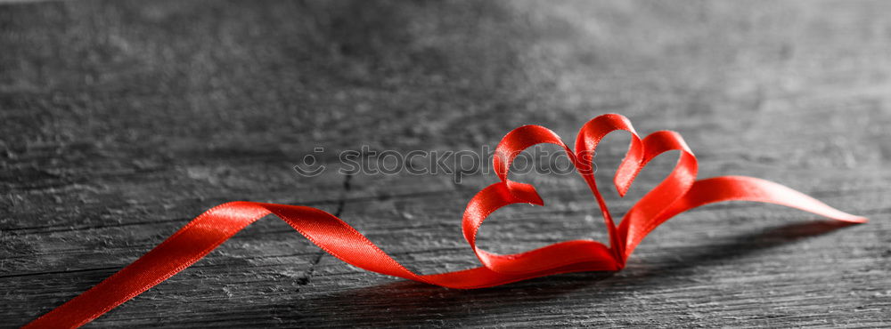 Image, Stock Photo Red star made of felt with plaid band, lies on old wood. Red poinsettia, as decoration on rustic brown wooden board. Star as a shield, Christmas tree pendant, gift pendant made of fabric for the Advent season, Christmas time with ribbon with checkered band.