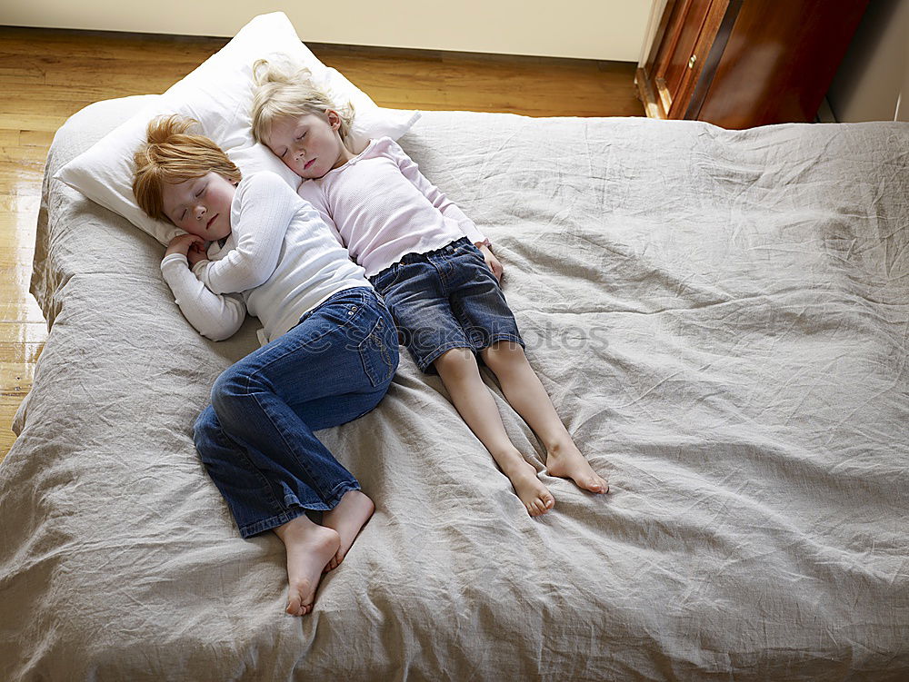 Similar – Brother and sister tickling and laughing on bed