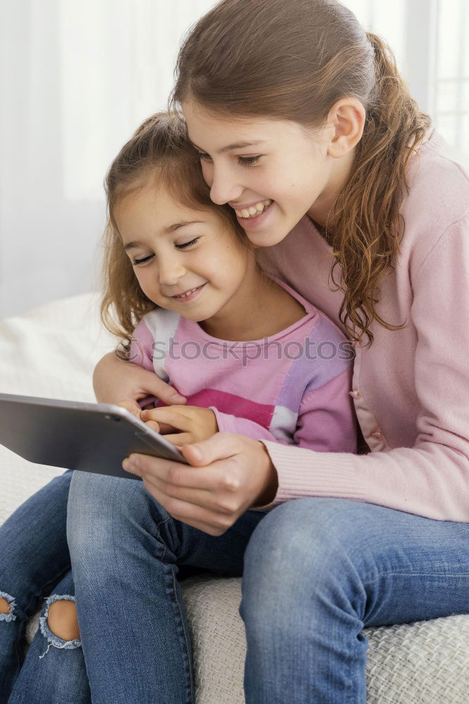 Similar – Mother and her child with digital tablet.