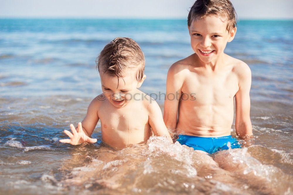 Similar – Two happy children playing on the beach