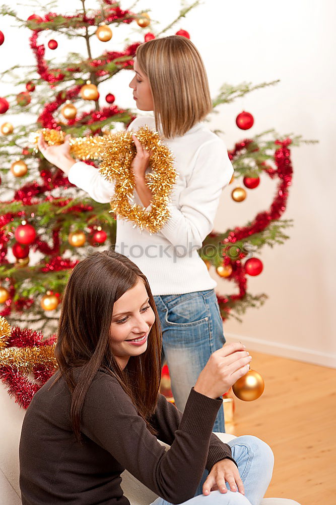 Similar – Young girl and her little sister decorating Christmas tree