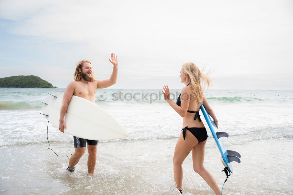 Similar – Aerial view of a surfing couple laying on the beach