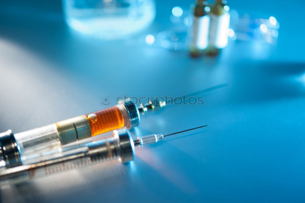 Similar – Small bottle of medicine and syringe on blue background