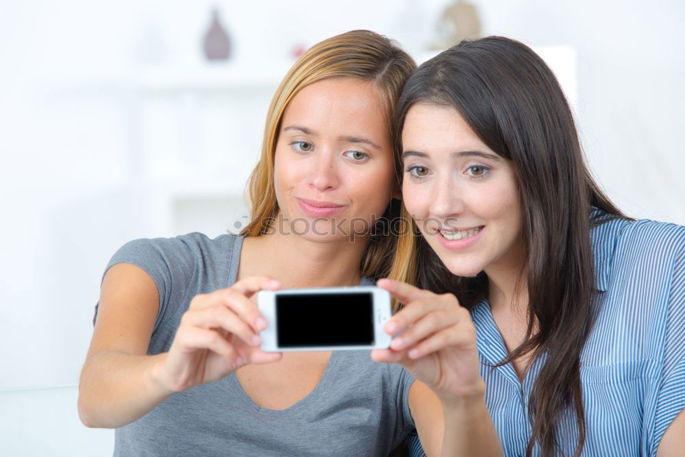Similar – Image, Stock Photo Women at home sitting on sofa while using a tablet PC