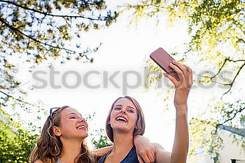 Similar – Beautiful women taking a selfie portrait in park.