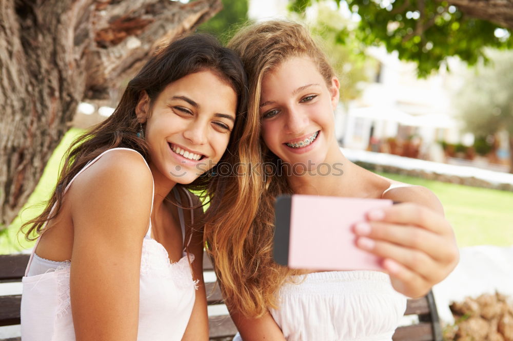 Similar – Beautiful women taking a selfie portrait in park.