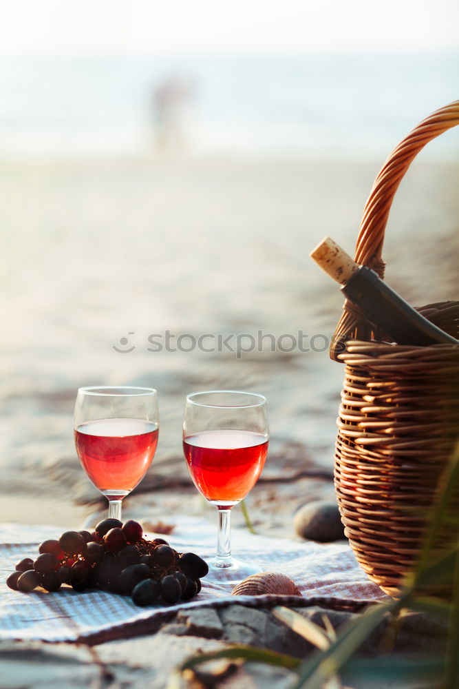 Similar – Image, Stock Photo Two wine glasses, wicker basket on beach