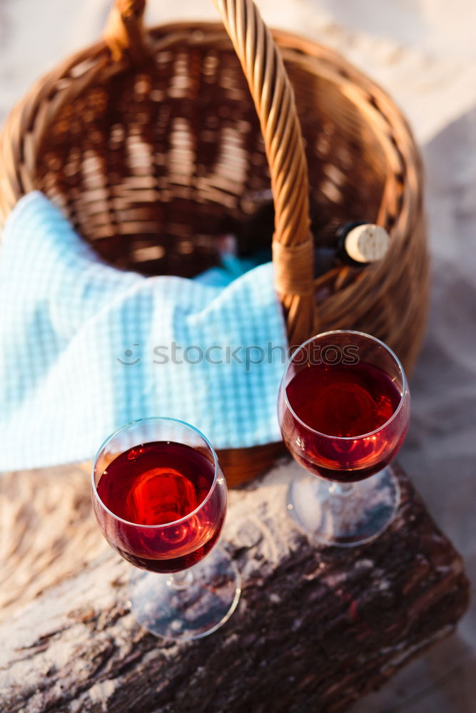 Image, Stock Photo Two wine glasses, grapes, wicker basket on beach