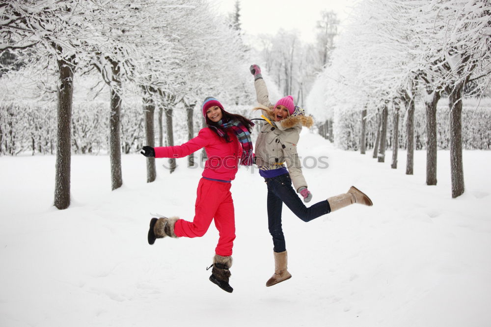 Similar – Teenage girl pulling sled with her little sister through forest