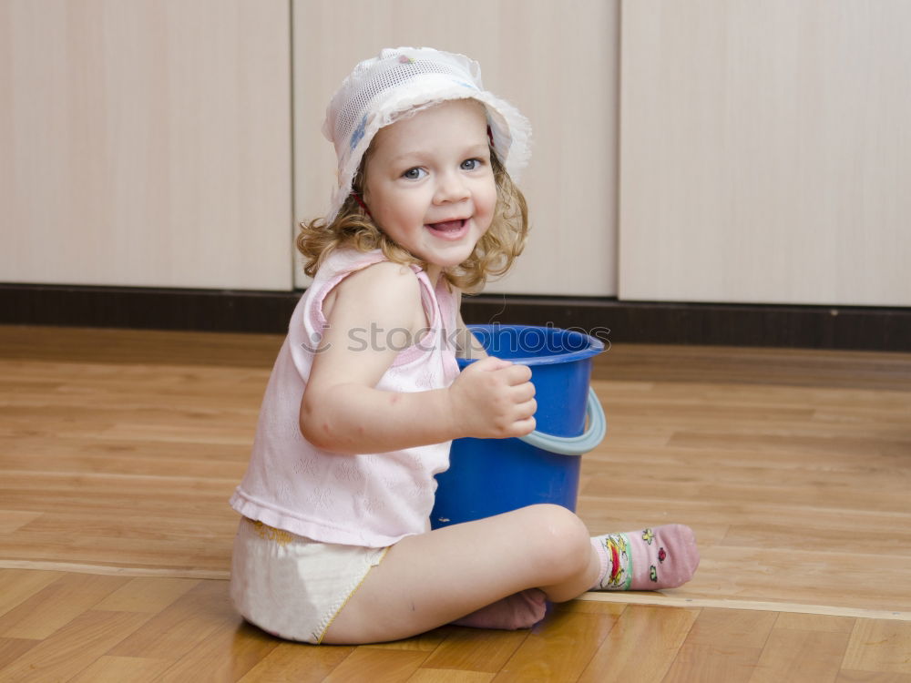 cute toddler girl put on socks at home