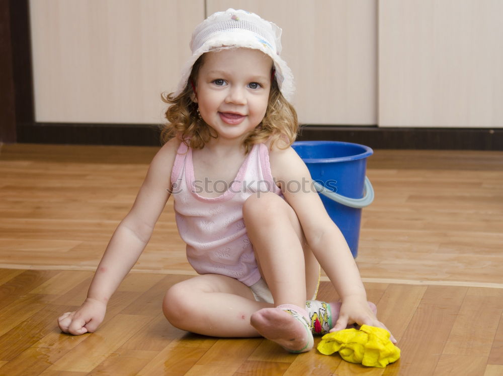 Similar – cute toddler girl put on socks at home