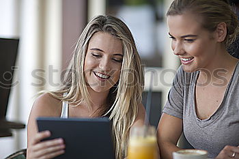 Similar – Image, Stock Photo Two male teenagers surfing the internet on tablet computer while sitting in cafe. One young man pointing at screen