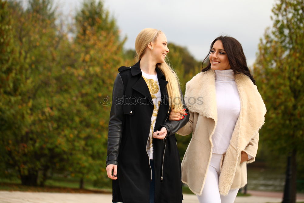 Similar – Two girls sitting on the bench and smile