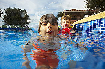 Similar – two little girls playing in the pool at the day time