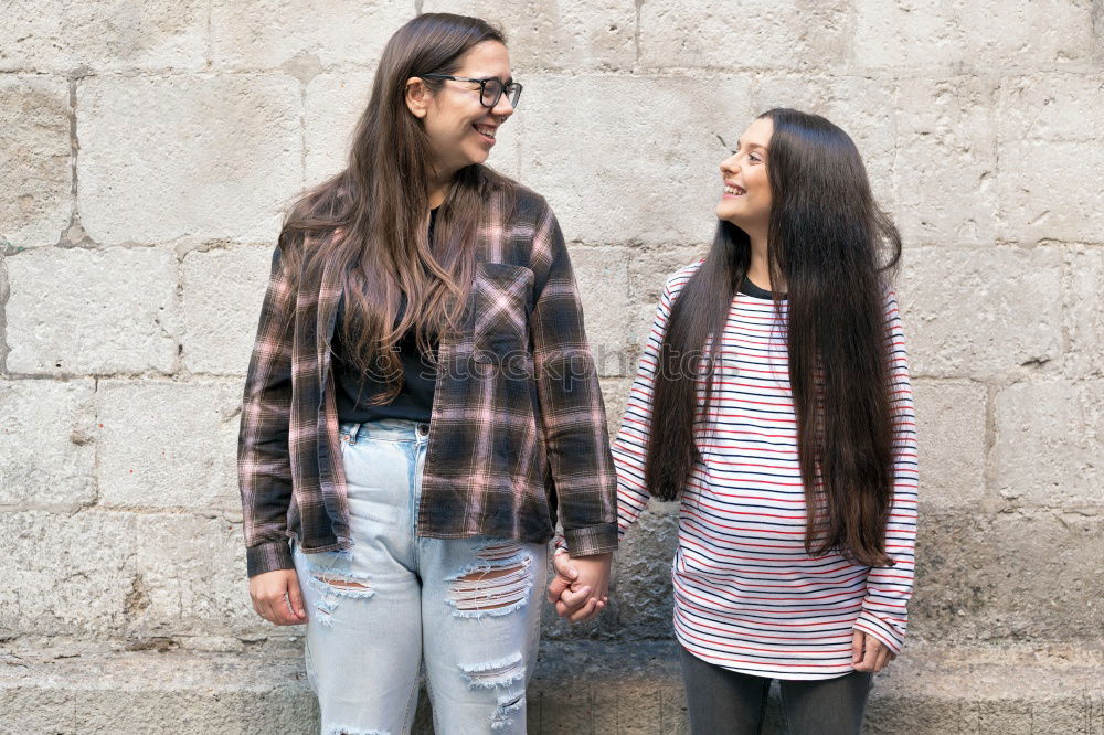 Similar – Two young women talking and laughing on urban steps