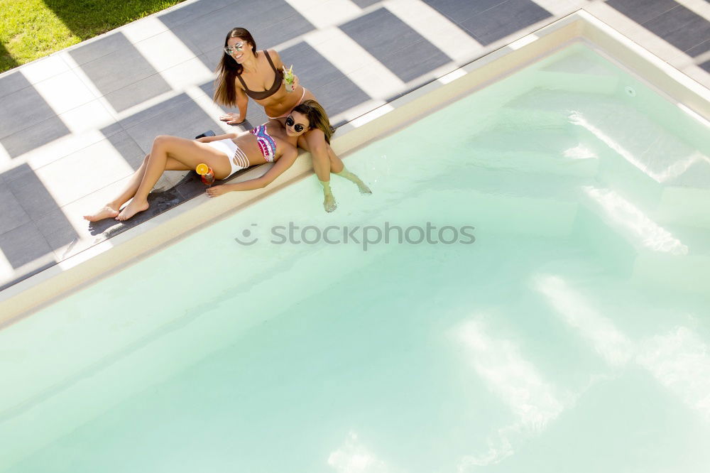 Similar – Two young women in swimsuits relaxing in the swimming pool