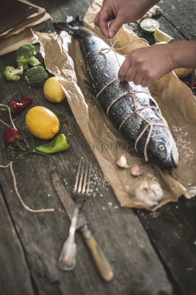 Similar – Tying a rope on fish for grilling