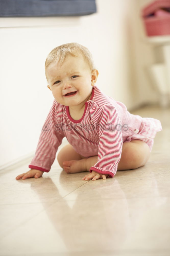 Similar – cute toddler girl put on socks at home