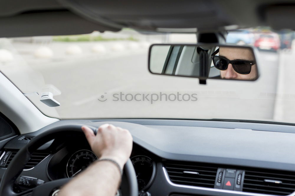 Similar – Image, Stock Photo Young man holding steering driving