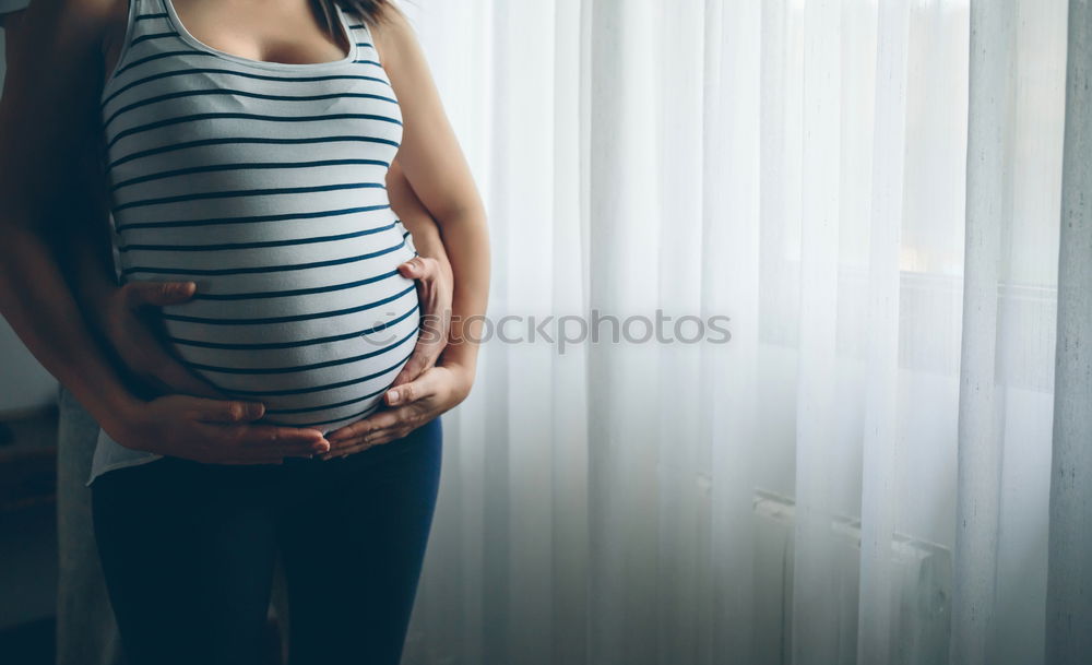 Similar – Who am I? Young woman holding a round mirror in front of her body. The mirror is showing her blurred face.